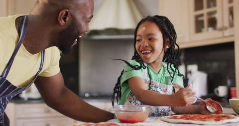 Joyful African American Family Preparing Pizza at Home