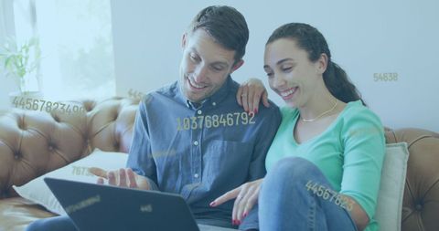 Couple Using Laptop with Digital Data Overlay