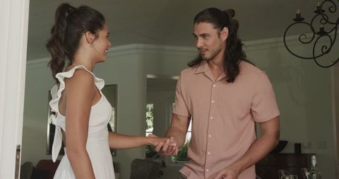 Man Proposing to Woman Indoors with Joyful Embrace