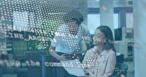 Reviewing Code Together in Modern Open Office with Glass Panels and Digital Code Overlay
