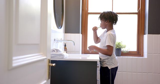 Young Boy Brushing Teeth in Modern Bathroom - Download Free Stock Images Pikwizard.com