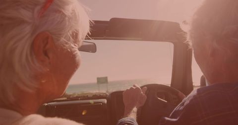 Senior Couple Enjoying Scenic Road Trip in Convertible Car