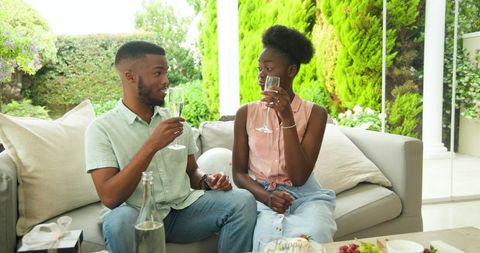 Couple Enjoying Drinks and Chatting on an Outdoor Patio