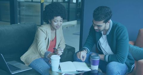 Focused Coworkers Collaborating in Modern Office Lounge