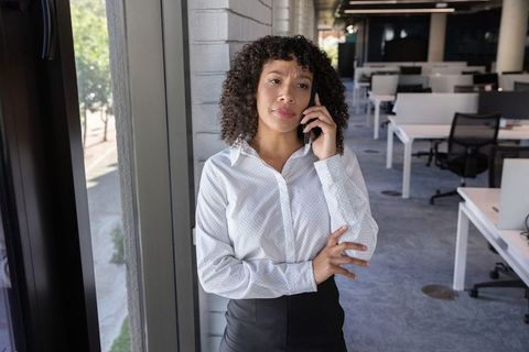 Businesswoman Discussing on Smartphone in Modern Office