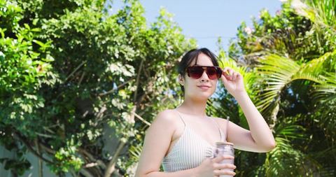 Outdoor relaxation with sunlit garden and refreshing drink