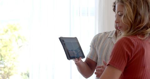 Couple relaxing at home with tablet proximity modern home interior