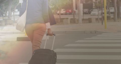 Woman Crossing City Street with Suitcase on She Shoots Online.
