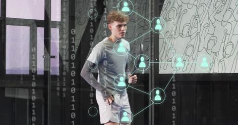 Young man jogging through glass lobby with digital network overlay and mural art