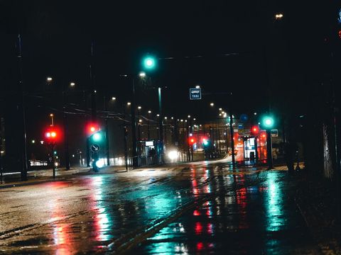 Moody urban street at road night with reflections