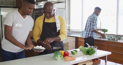 Father and Son Cooking Together Preparing Vegetables