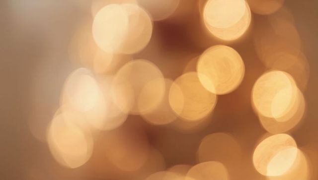 Golden Bokeh Lights Background Creating Warm Ambient Glow for Holiday and Event Design