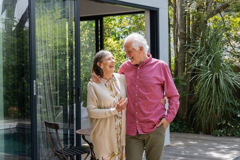 Senior Couple Enjoying Leisurely Walk on Sunlit Deck