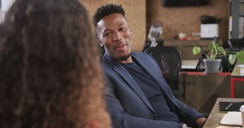 Casual business meeting between diverse colleagues in modern office