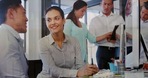 Diverse team collaborating in modern office with graphic overlays