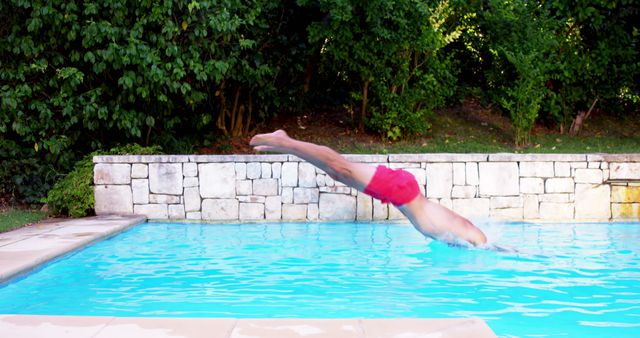 Man Diving into Swimming Pool on Sunny Day - Download Free Stock Images Pikwizard.com