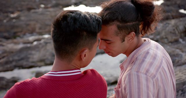 Diverse gay male couple touching foreheads by the sea at sunset - Download Free Stock Photos Pikwizard.com