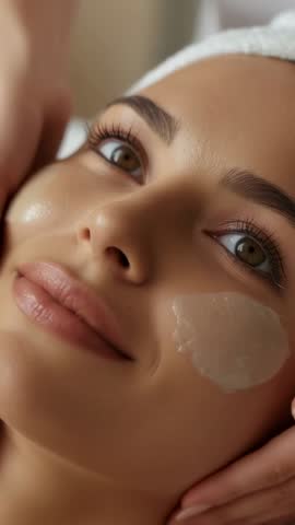 Spa therapist massaging and smoothing hydrogel eye patch on face vertical beauty video