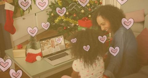 Mother and Daughter Connecting with Family Online During Christmas