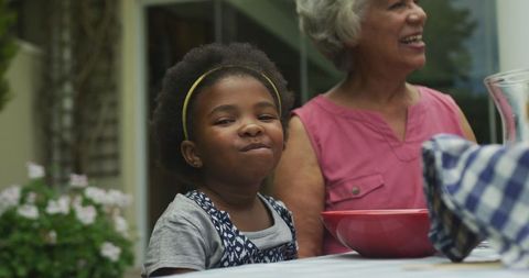 Joyful Child Sharing Breakfast Outdoors with Family