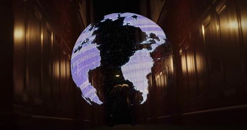 Glowing earth hologram display in narrow wood corridor