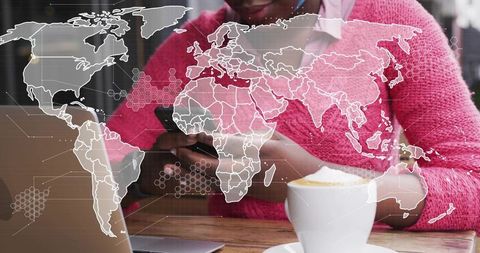 Woman tapping smartphone at cafe with laptop and global data overlay, remote work concept