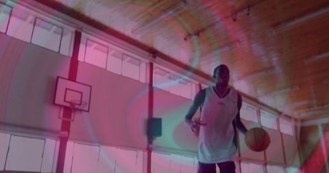 Dynamic Athlete Dribbling Basketball on Indoor Court