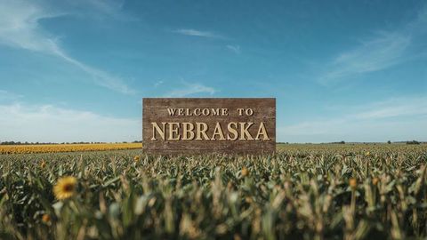 Rustic Nebraska Welcome Sign in Lush Farmland