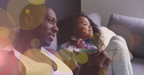 Father and Daughter Bonding Watching TV on Sofa