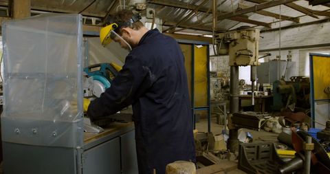 Focused Worker Using Machinery in Industrial Workshop - Download Free Stock Images Pikwizard.com