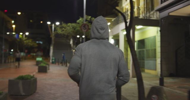 Person Walking Alone on City Street at Night in Hoodie - Download Free Stock Images Pikwizard.com