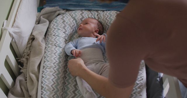 Image of caucasian mother putting asleep newborn baby - Download Free Stock Photos Pikwizard.com