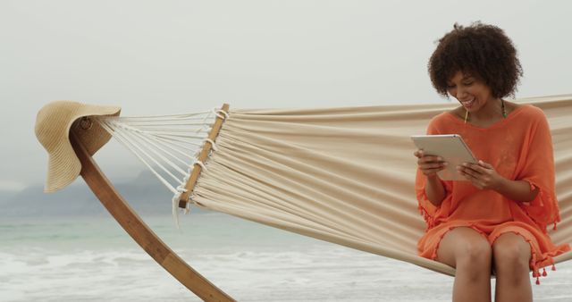 Young Woman Relaxing on Hammock at Beach with Digital Tablet - Download Free Stock Images Pikwizard.com