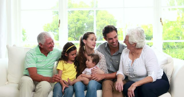 Three Generation Family Sitting on Couch, Enjoying Quality Time Together - Download Free Stock Images Pikwizard.com