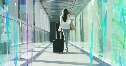 Business Traveler Walking with Luggage in Modern Corridor