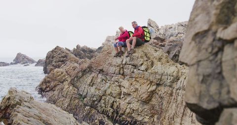 Senior Couple Hiking Rocky Shoreline with Backpacks - Download Free Stock Images Pikwizard.com