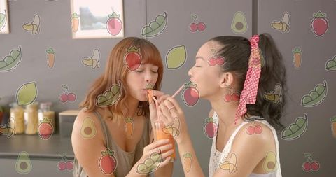 Two friends sharing orange juice through dual straws in cozy kitchen, playful summer moment