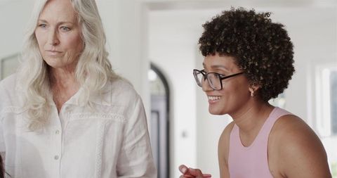 Bride preparing for wedding with stylist and smartphone