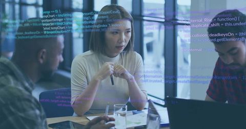 Business collaboration in modern office with digital code overlay