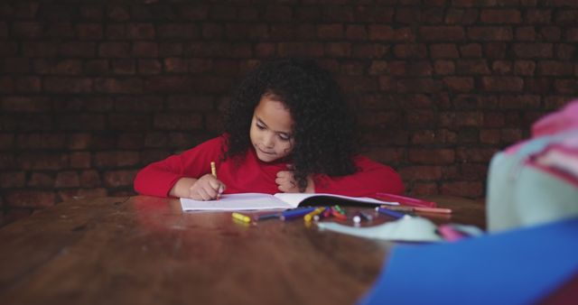 Focused Girl Drawing at Home Table with Crayons - Download Free Stock Images Pikwizard.com