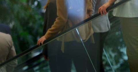 Business People on Escalator in Office Complex