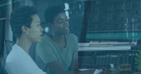 Women collaborating on encryption code at glass monitor for cybersecurity and software
