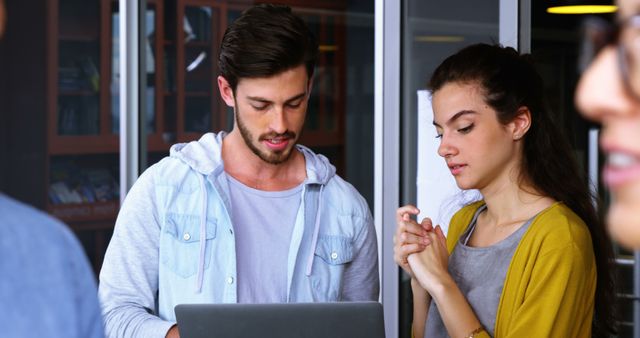 Young Professional Man and Woman Collaborating in Office - Download Free Stock Images Pikwizard.com