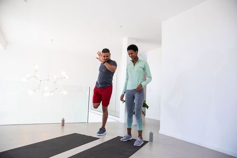 Couple Practicing Balance Exercises on Yoga Mats at Home