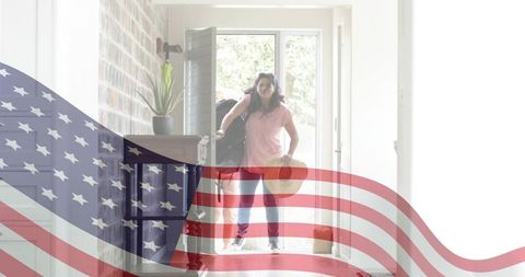 Senior women returning home with luggage and sunhat under waving american flag overlay