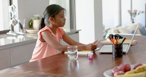 Young Girl Studying at Home with Laptop in Kitchen - Download Free Stock Images Pikwizard.com
