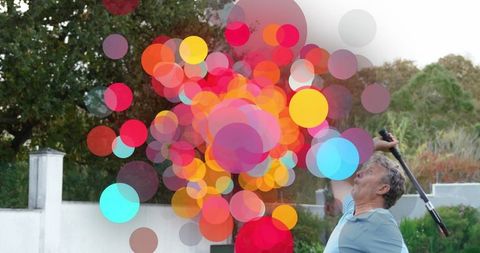 Energetic Senior Playing Tennis with Burst of Colors