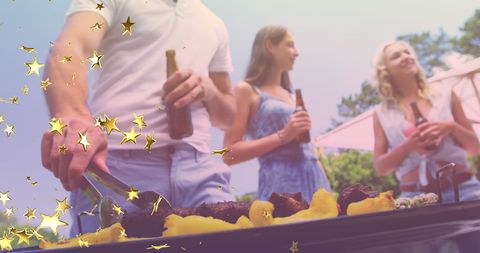 Friends Enjoying Backyard BBQ with Drinks and Celebration