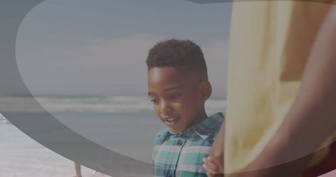 Young Boy Holding Hand by Seaside Beach