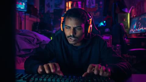 Intense Gamer Reacting to Sudden Event in Neon-Lit Room